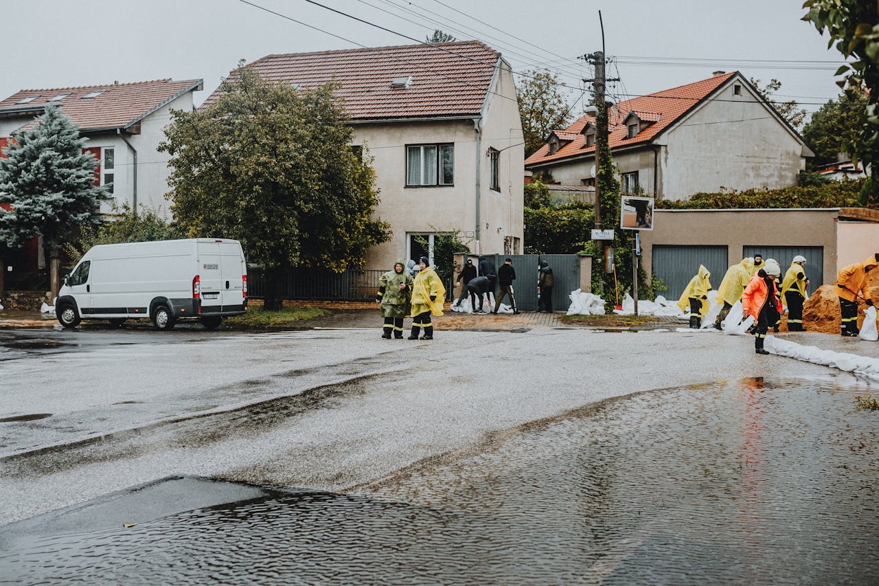 Home Emergency response team tackles flooding in a residential neighborhood with sandbags and preparation.